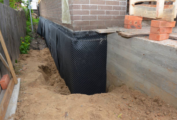 Happy homeowners after waterproofing job in Monticello